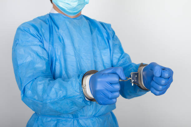 Close up picture of handcuffs surgeon going to jail because of malpractice