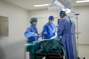 Hospital health care and medicine. One female doctor reaching out for a surgical tool.